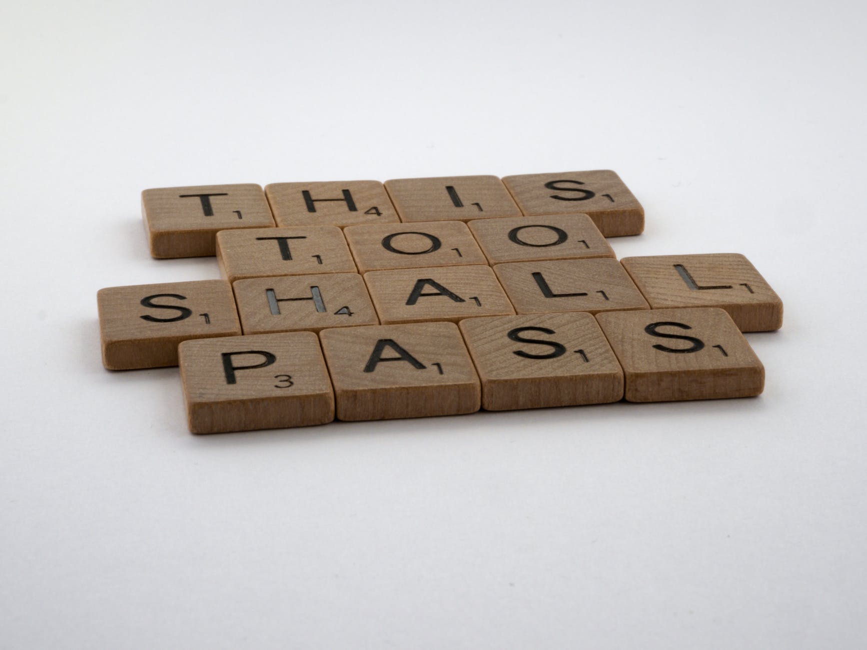 wooden scrabble pieces on white surface