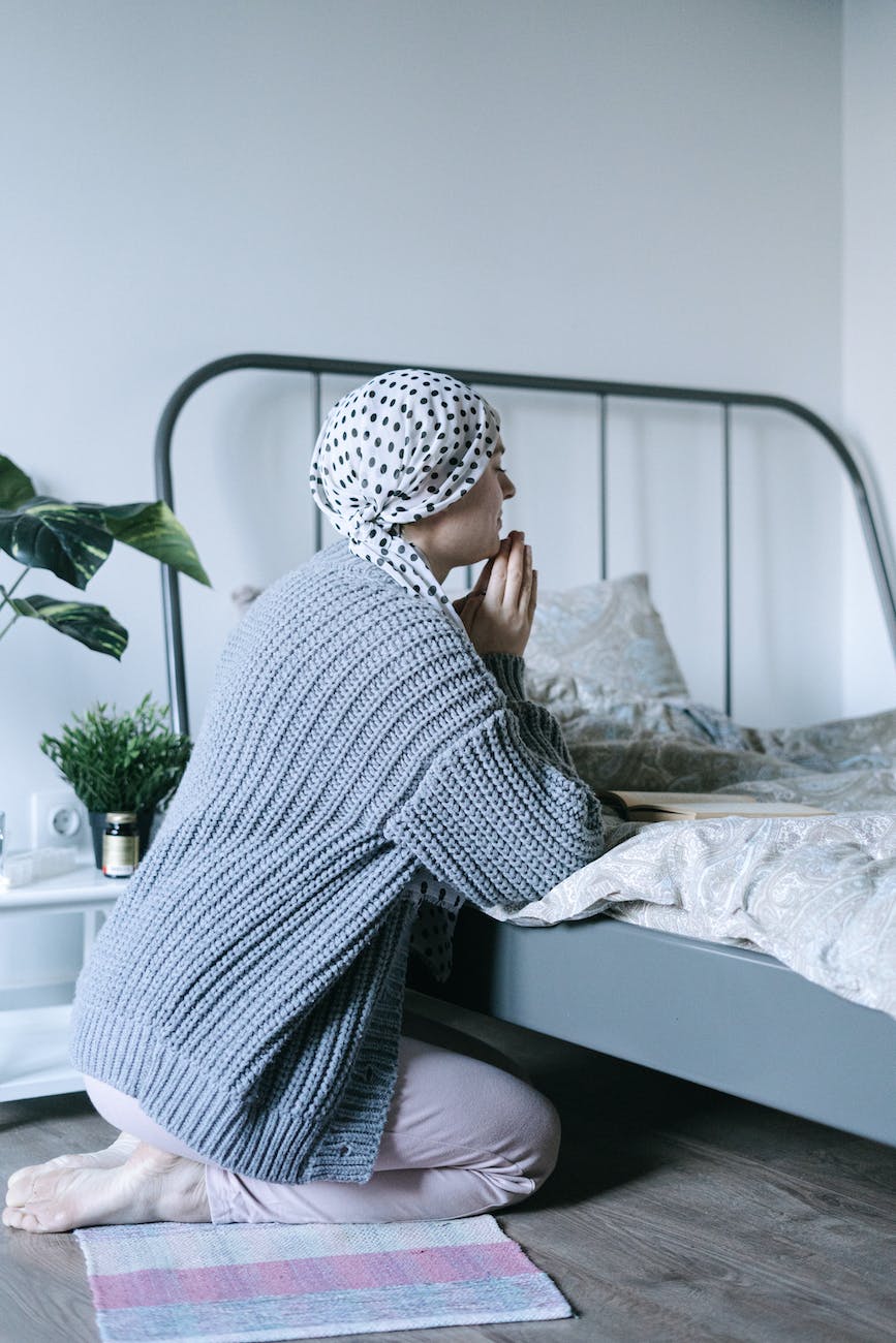 woman in white and black hijab sitting on bed