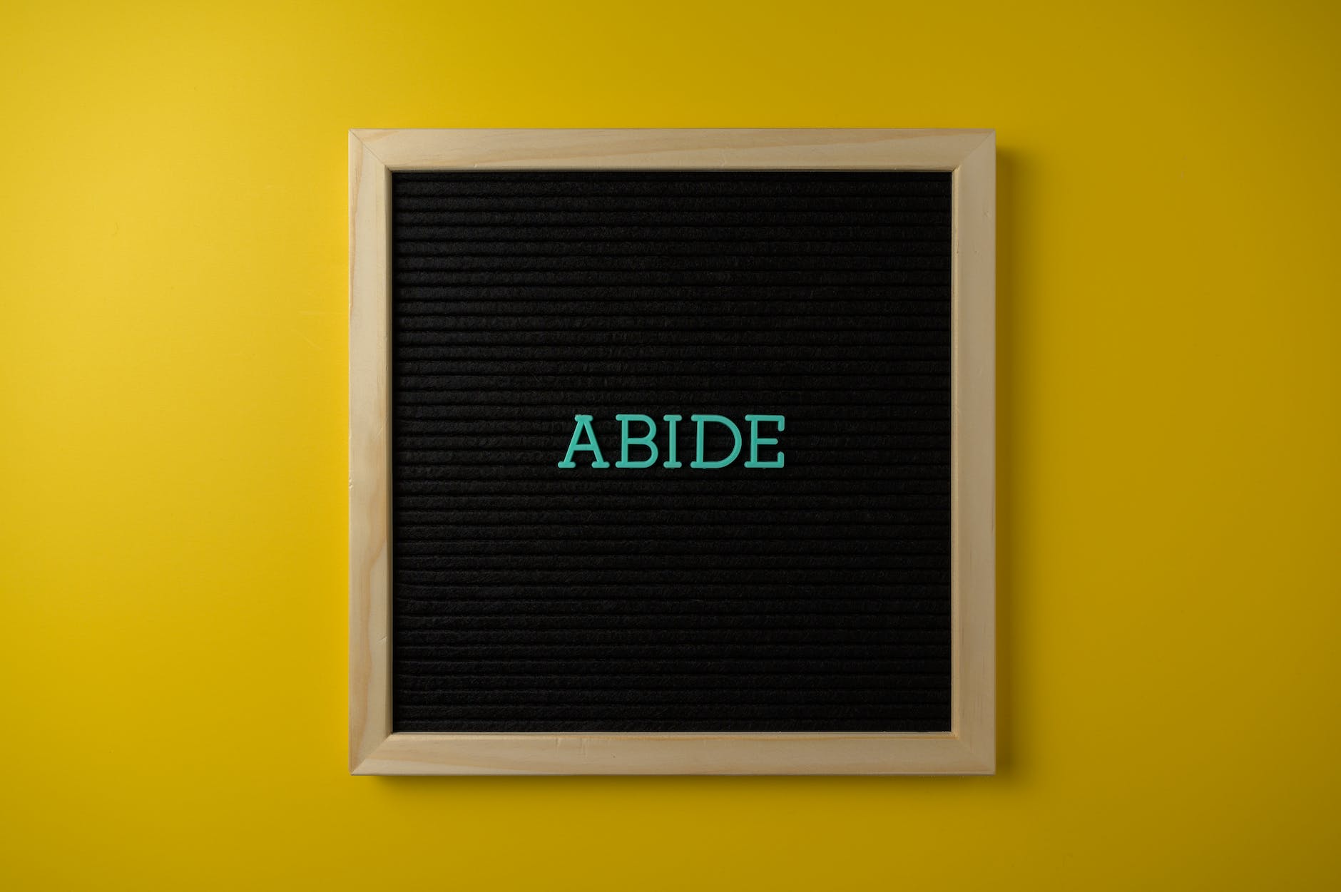 wooden framed text board on yellow background
