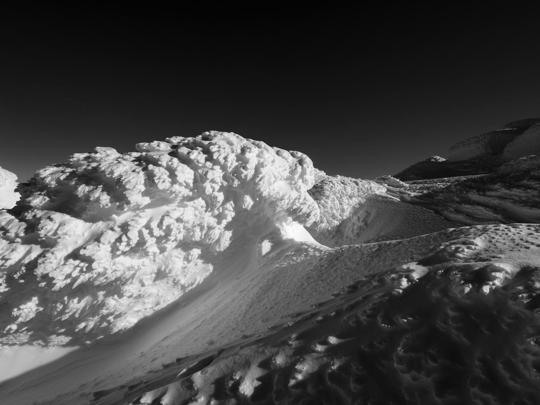 snow falling down the mountain in an avalanche