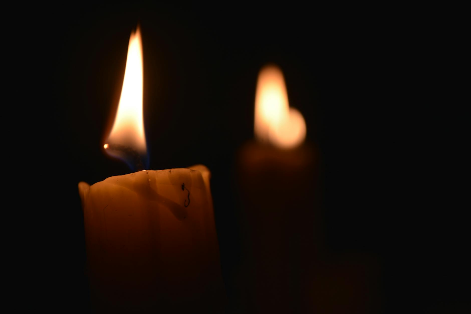 candles with burning flame in darkness