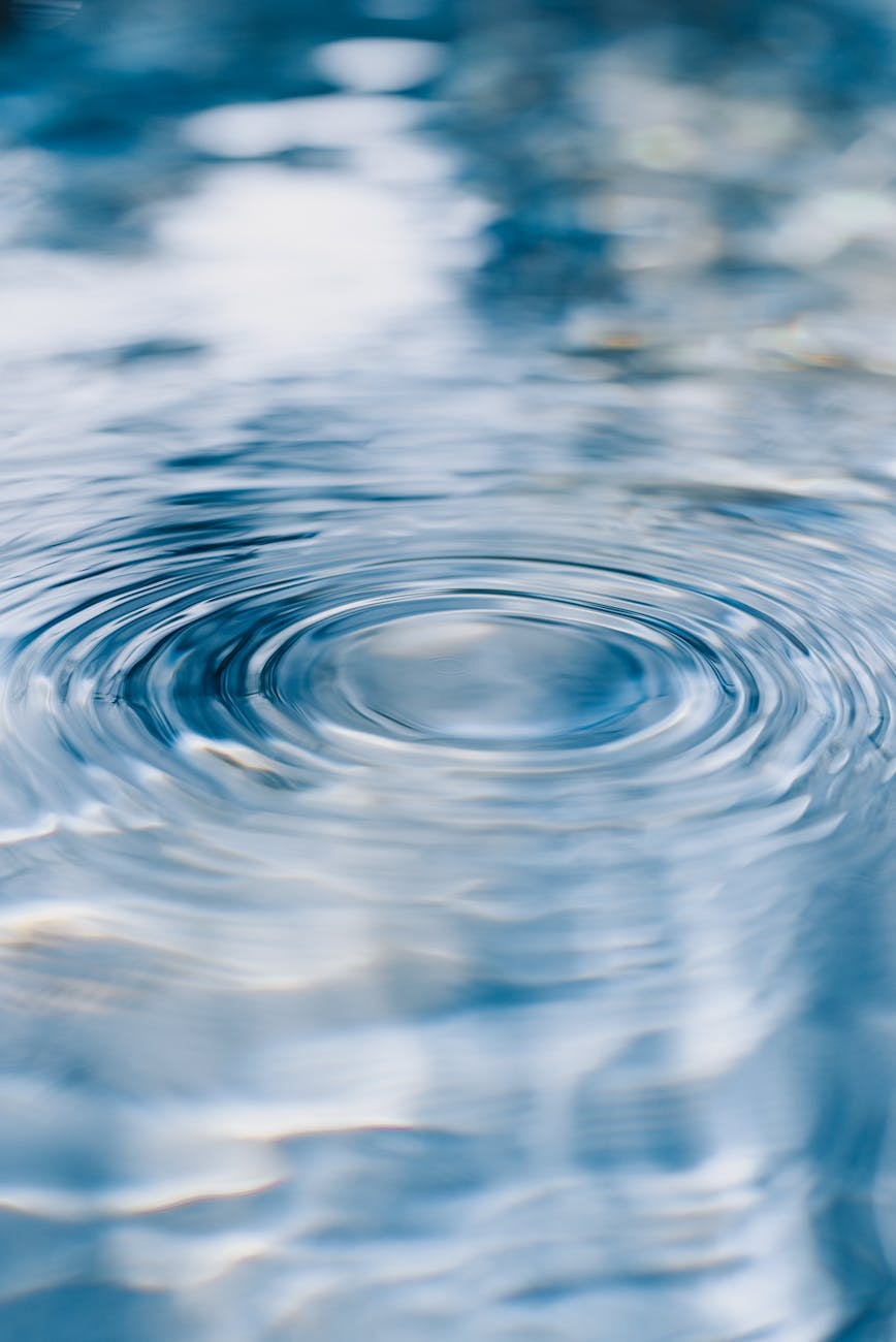 a close up of water ripples with a blue sky
