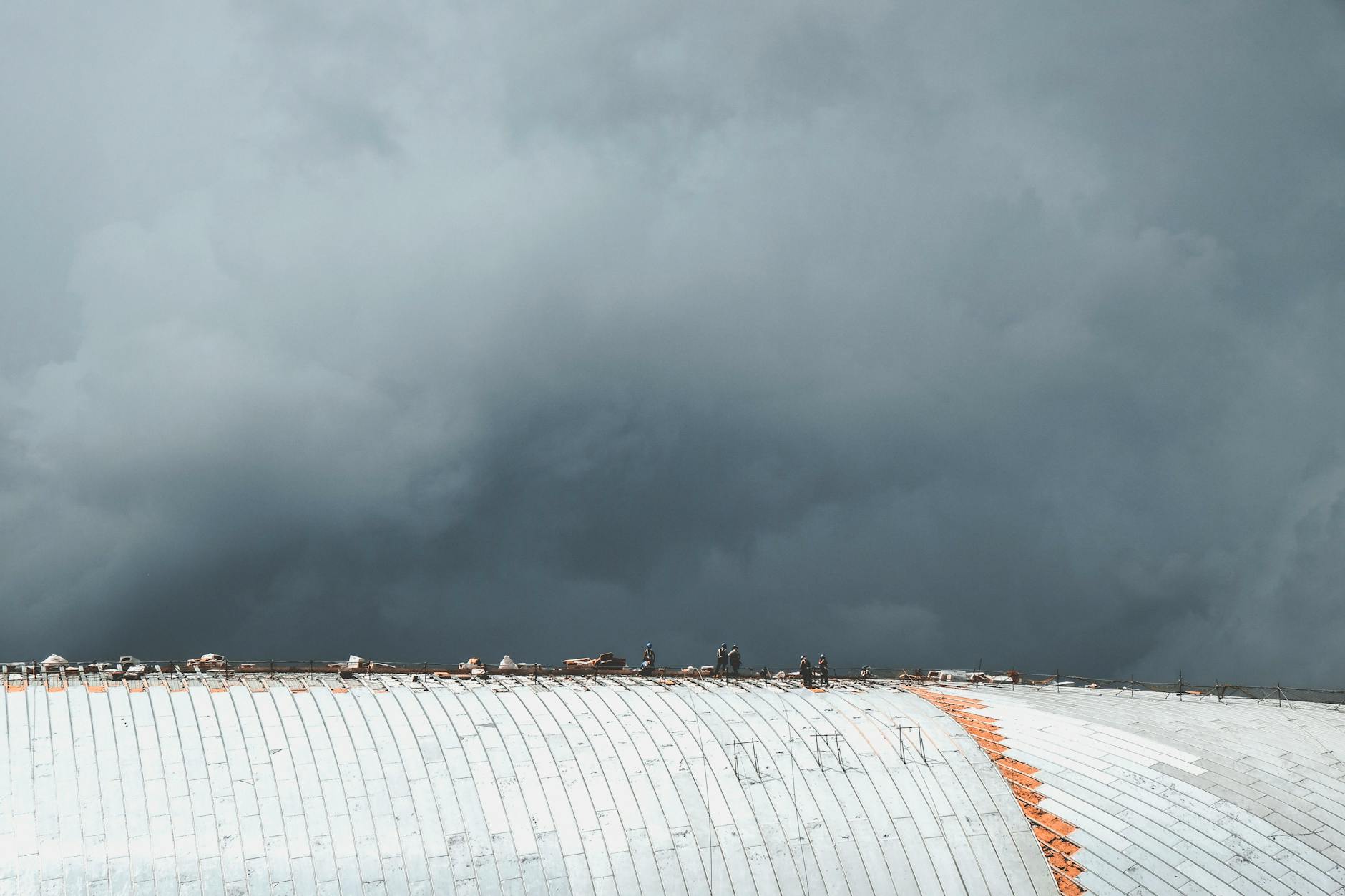 workers at the roof of a building