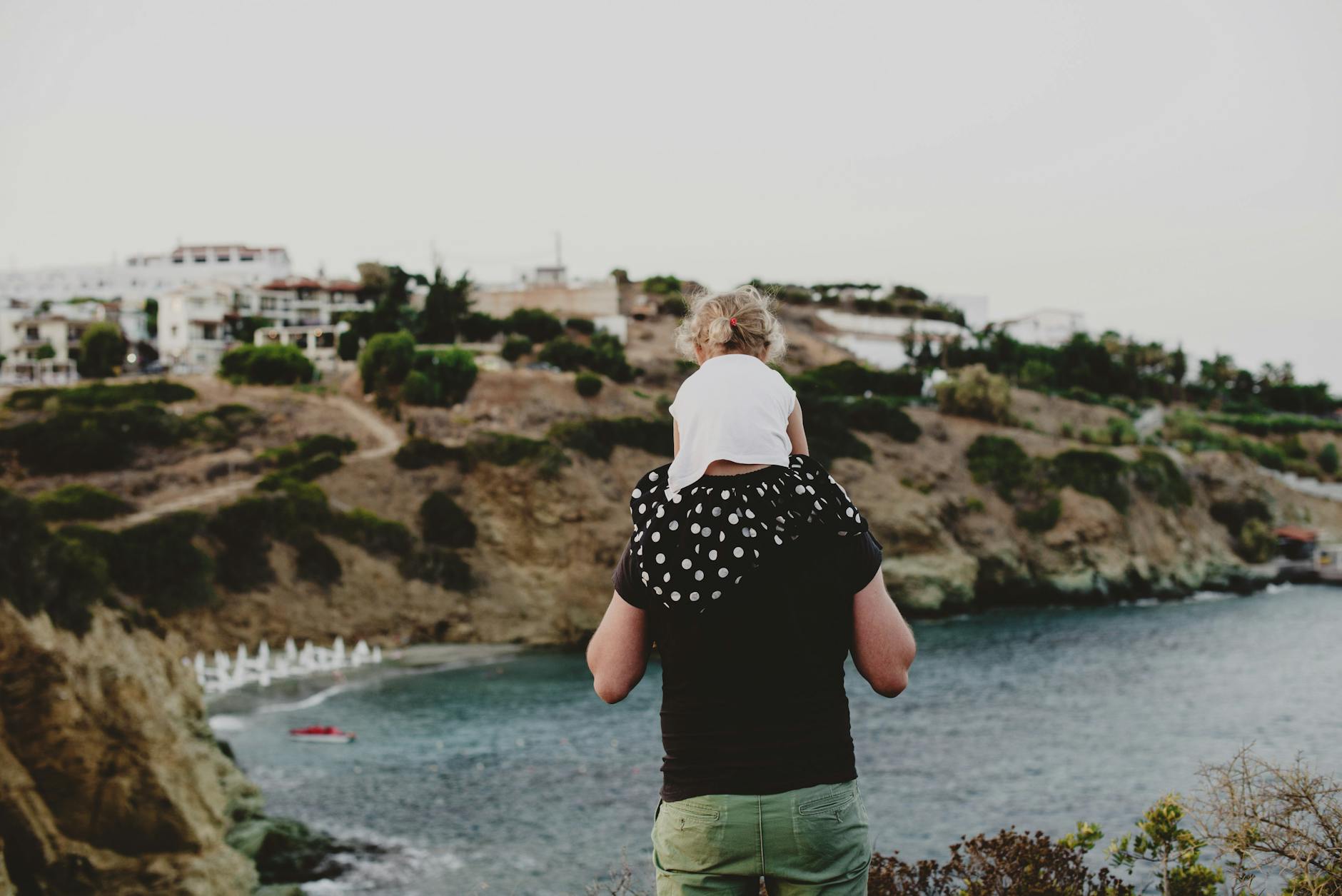 unrecognizable father giving piggyback ride to daughter