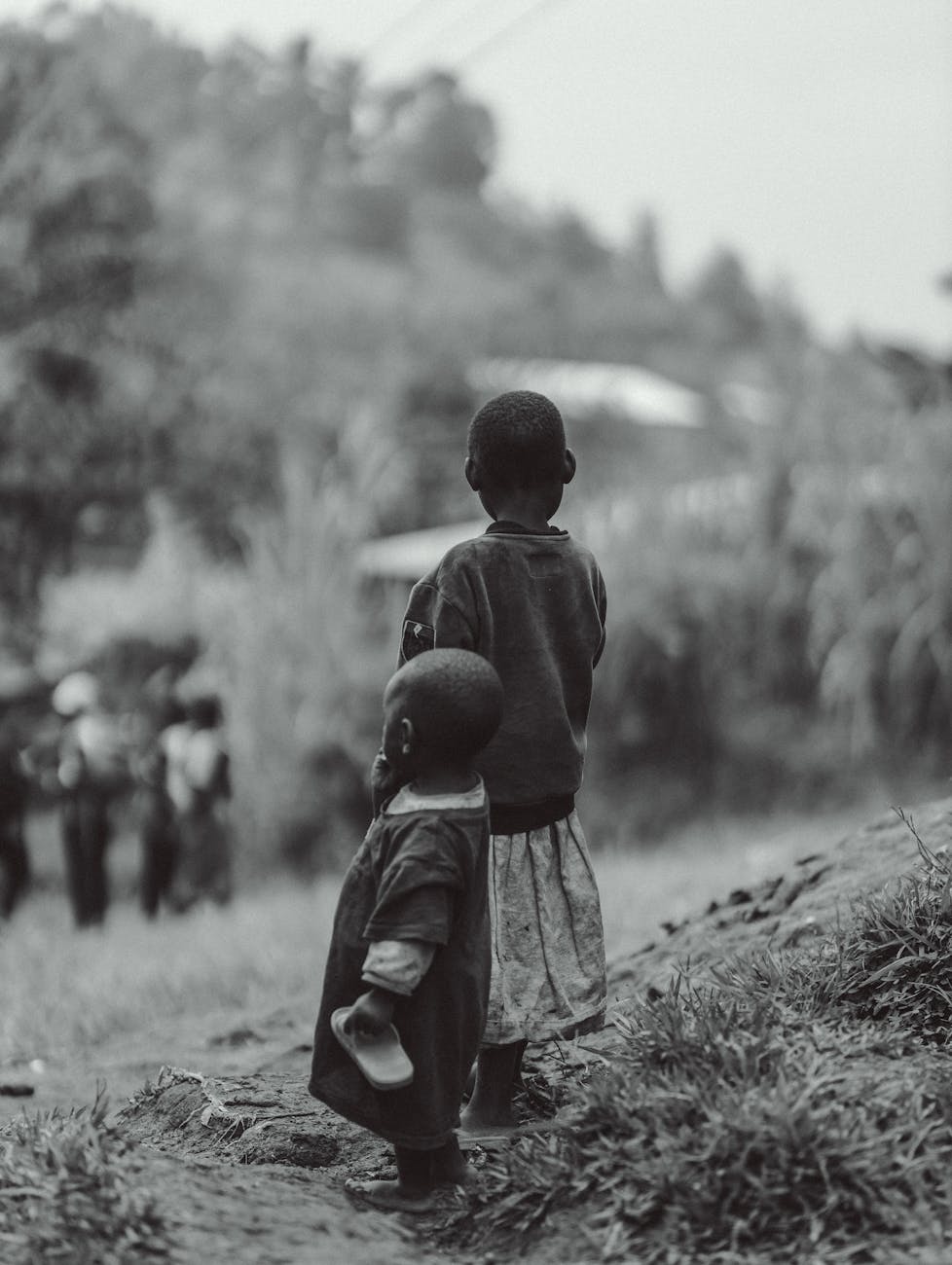 children walking in rural burundi landscape