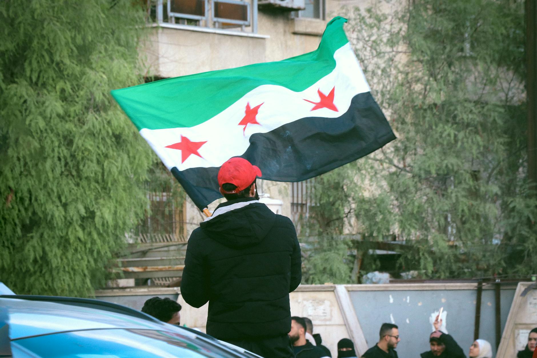 syrian flag raised in patriotic demonstration