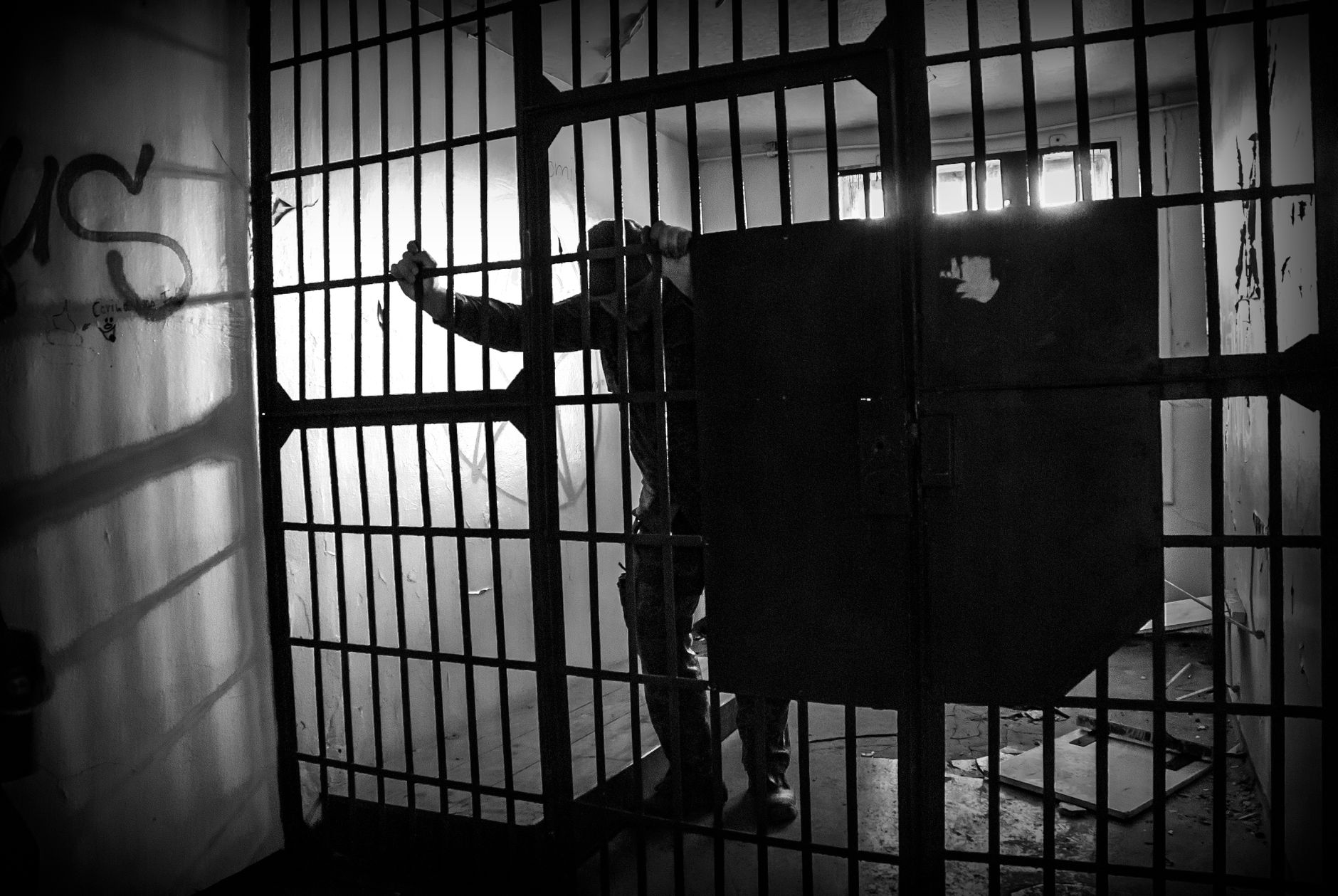 grayscale photo of a prisoner inside the jail